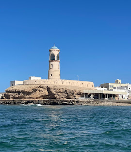 Al Ayjah Lighthouse above the rocky Sur shoreline