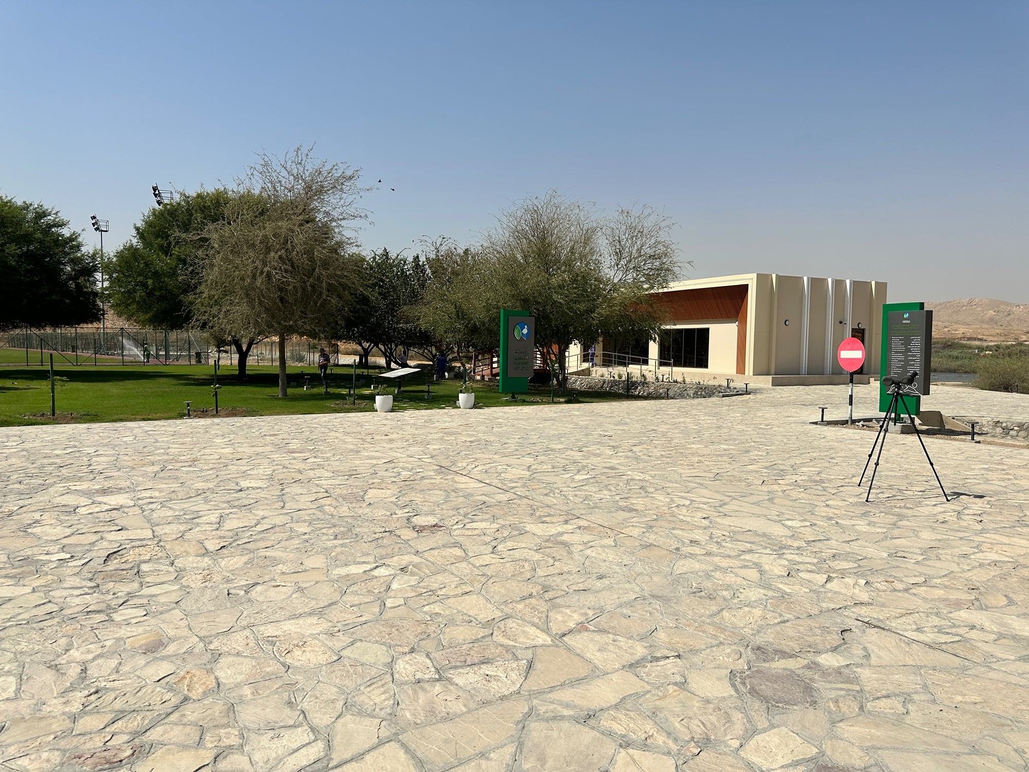 The Al Ansab Wetland visitor centre with a birdwatching telescope set up on the terrace