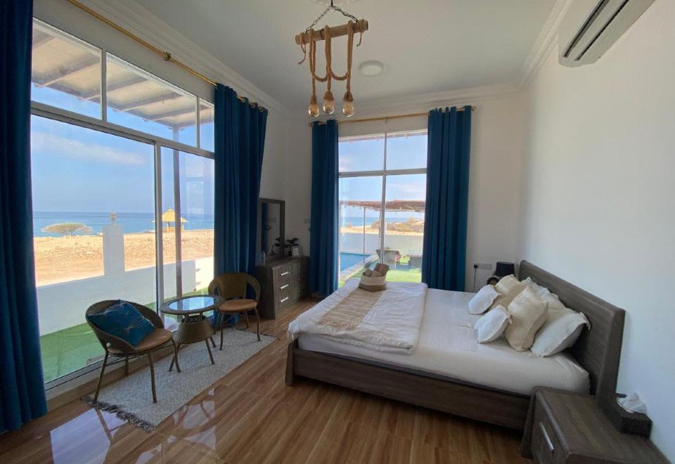 Sea-view bedroom at Wadi Shab Guest House overlooking Pebbles Beach